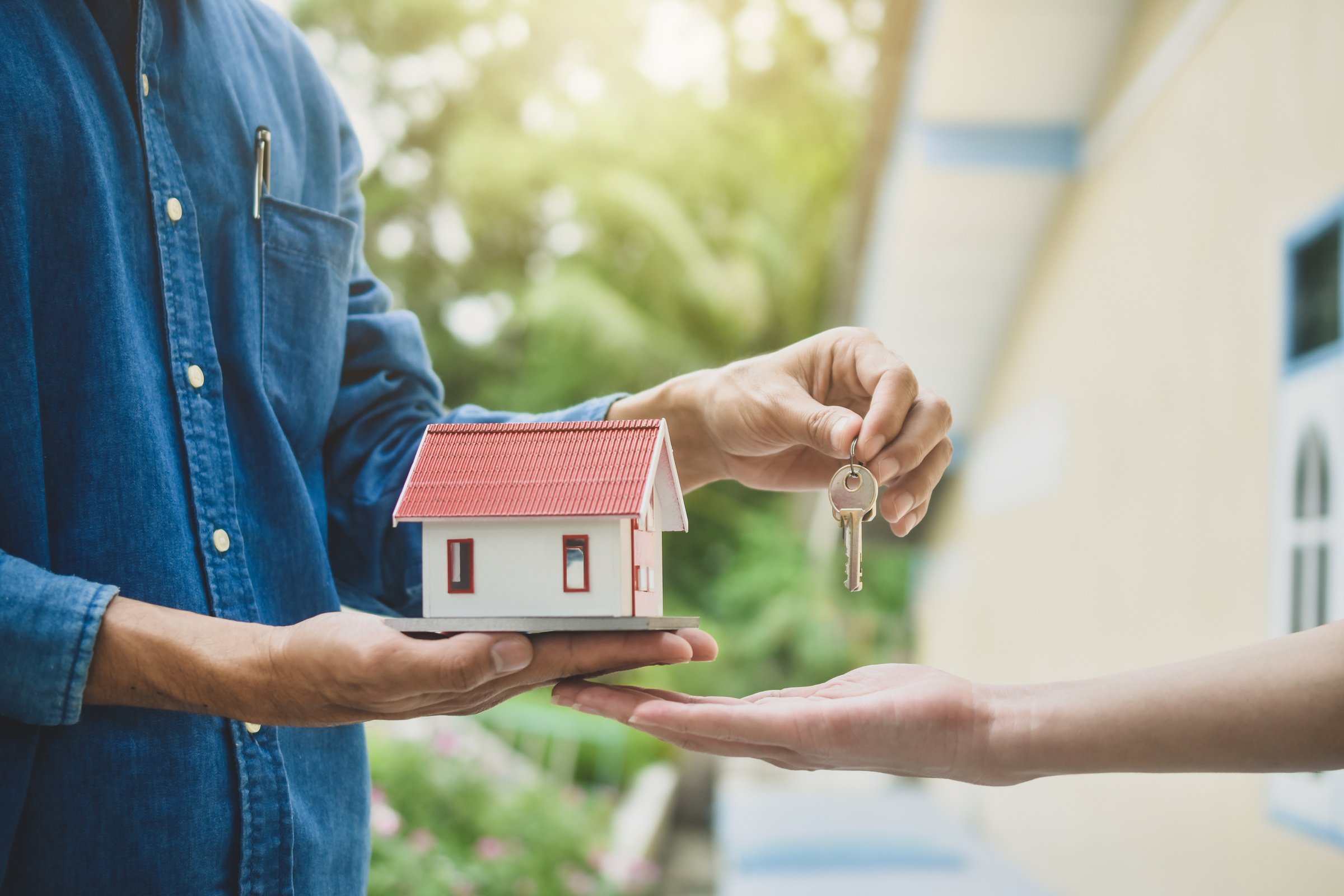 Man Holding House Model with Key 